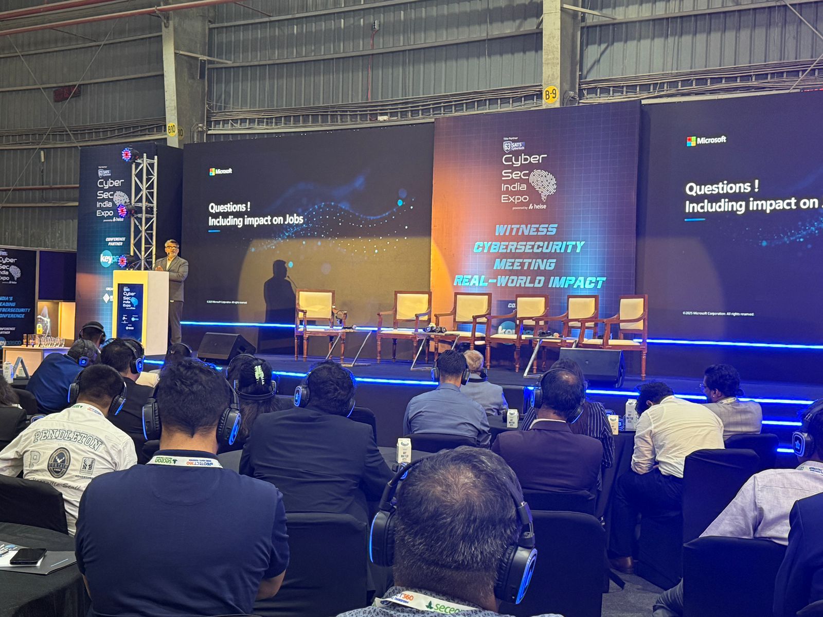 CyberSec India Expo 2026 conference stage with delegates listening on translation headsets