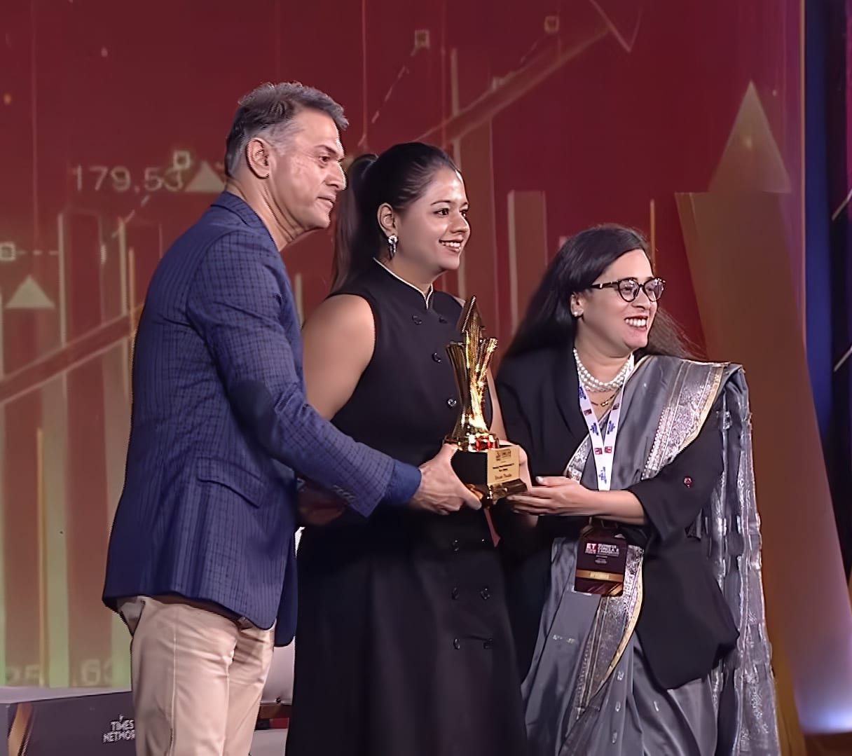 Close view of the trophy being handed to Shivani Tikadia on stage at the ETNOW.in Business Conclave and Awards 2026, West Edition