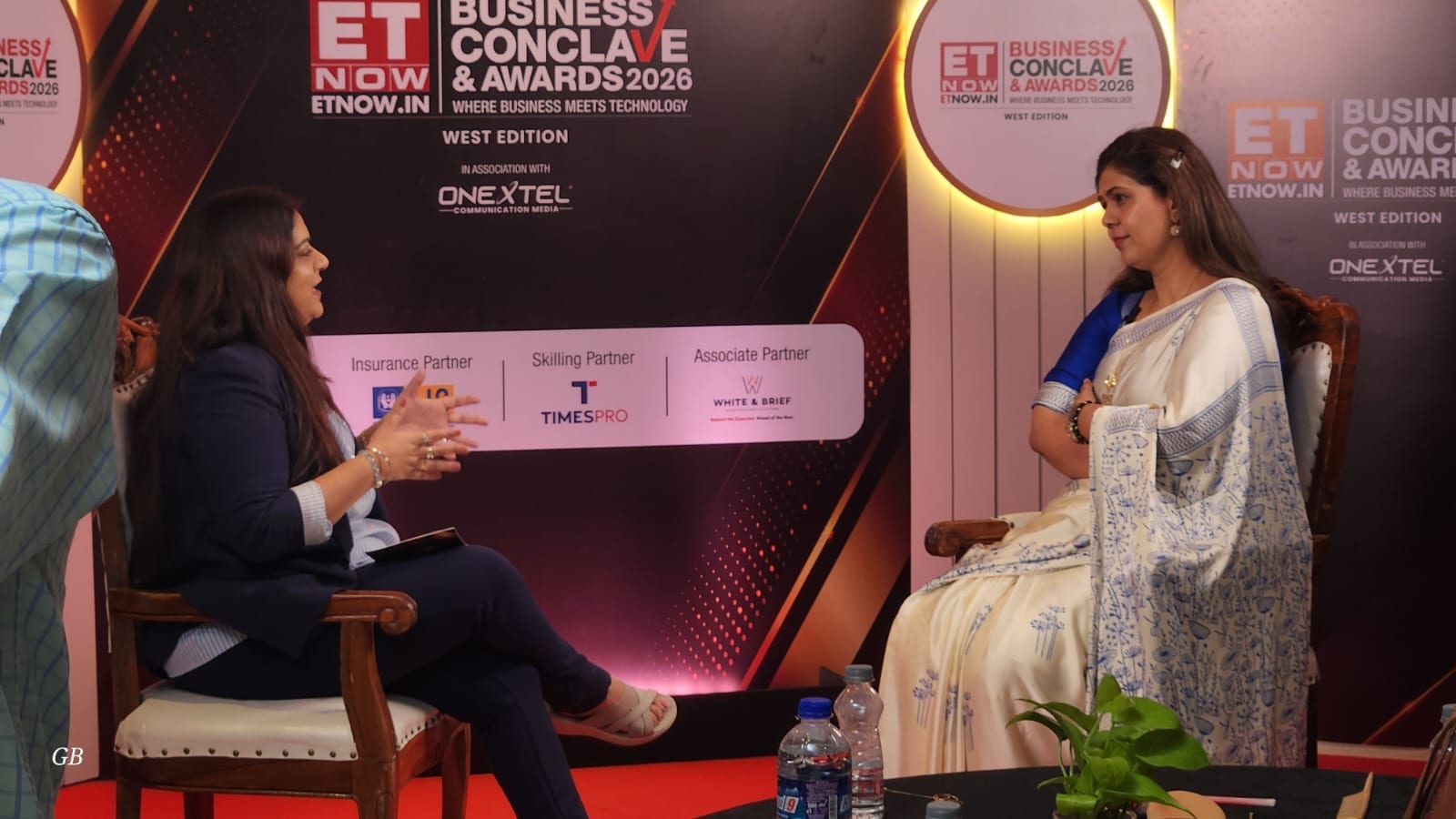Two speakers in conversation during a fireside session at the ETNOW.in Business Conclave and Awards 2026, West Edition
