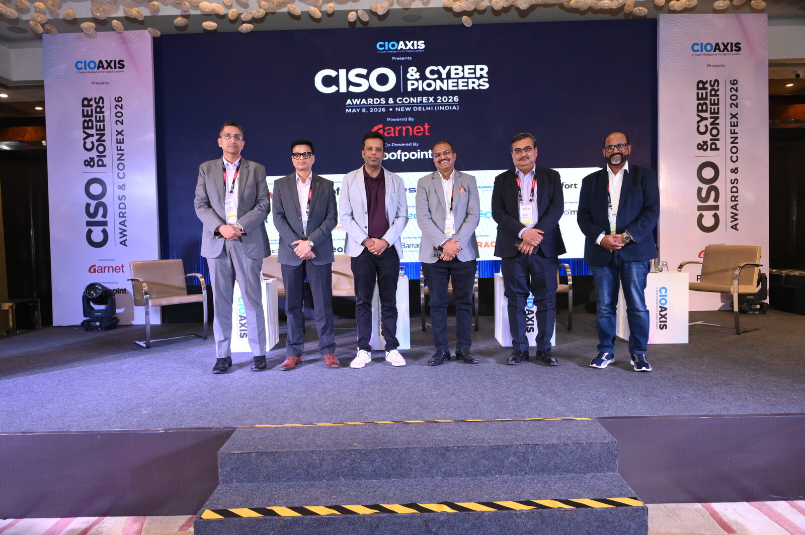 Stage group photo, CISO & Cyber Pioneers backdrop
